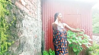 Village girl outdoor bath in rain