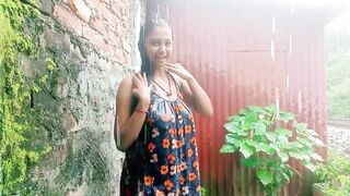 Village girl outdoor bath in rain