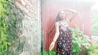 Village girl outdoor bath in rain